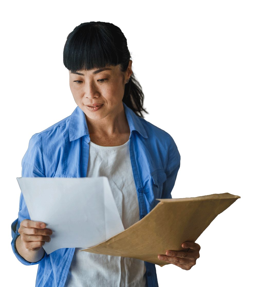 Woman looking down at a packet of paperwork